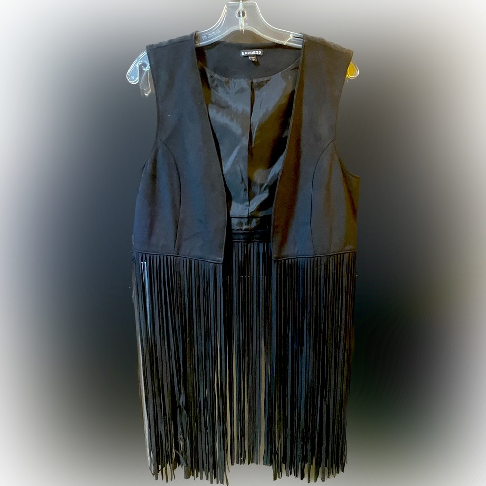 Sleeveless faux suede vest with fringe.